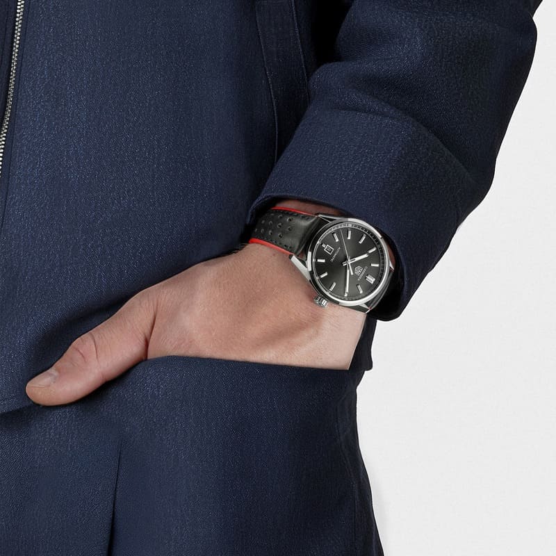 Tag Heuer watch pictured on a mans wrist with his hand in his trouser pocket 